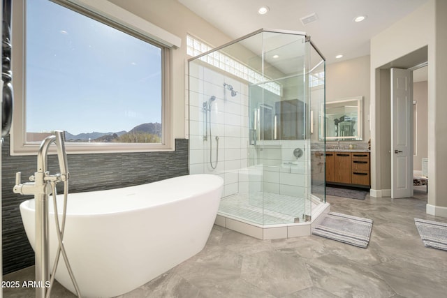 bathroom with shower with separate bathtub, a mountain view, and vanity