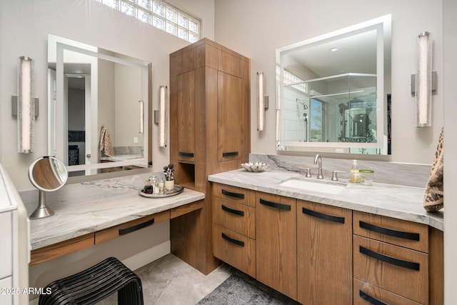 bathroom with a shower with door, tile patterned floors, and vanity