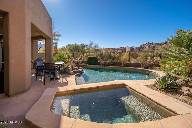 view of swimming pool with a patio area and an in ground hot tub