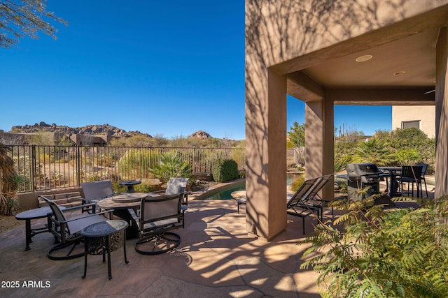 view of patio with a mountain view and area for grilling