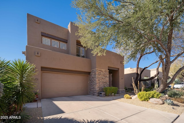 pueblo-style house with a garage