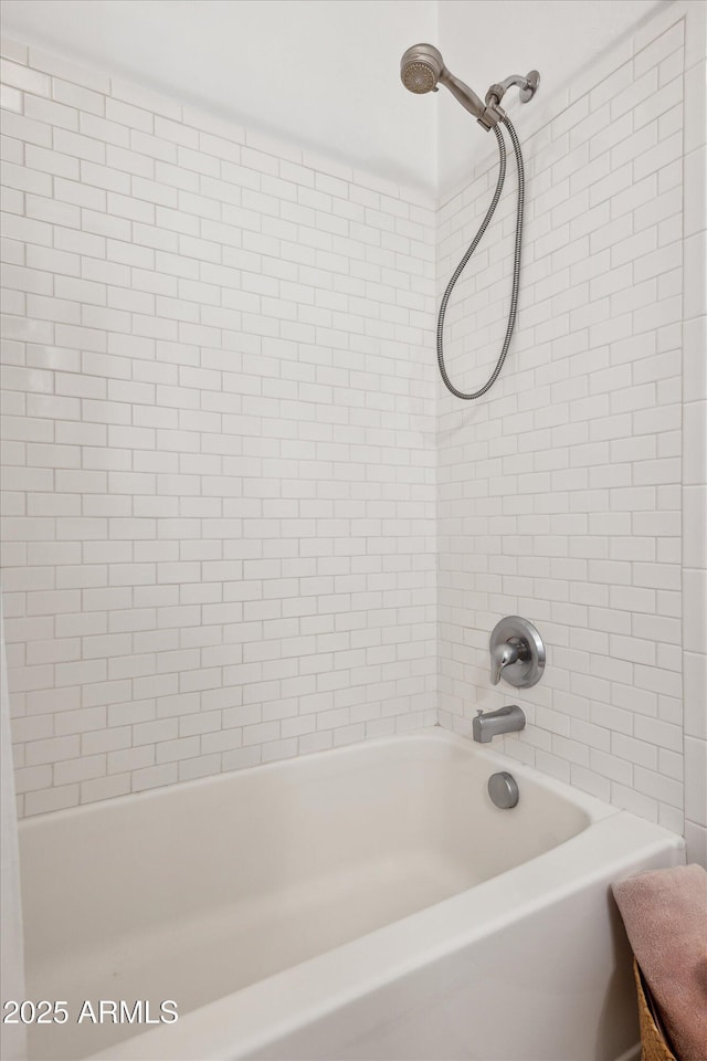 bathroom with shower / washtub combination