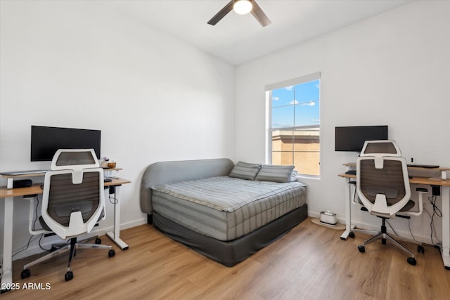 bedroom with baseboards, a ceiling fan, and wood finished floors