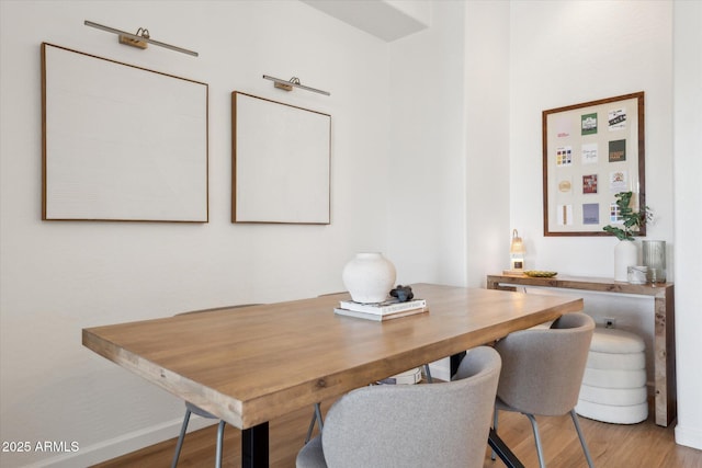 dining room featuring baseboards and wood finished floors