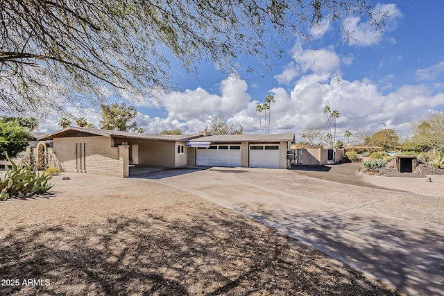 single story home featuring brick siding, concrete driveway, and a garage