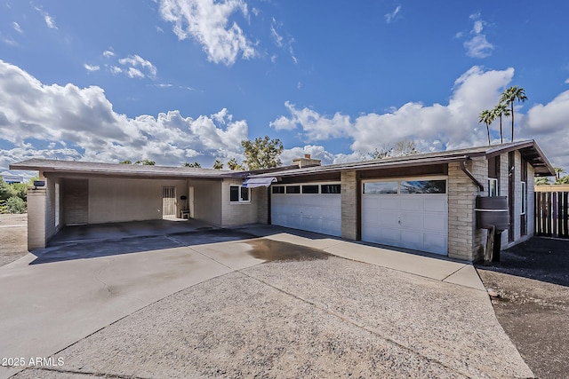 ranch-style home featuring driveway and a garage