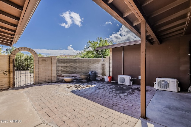 view of patio / terrace with ac unit, a gate, and fence