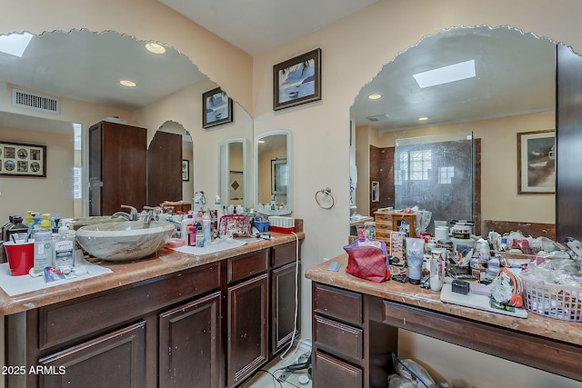 full bath featuring recessed lighting, visible vents, walk in shower, and vanity