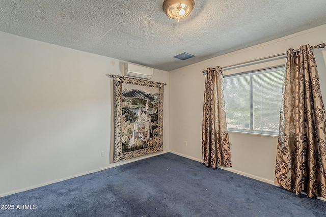 carpeted empty room featuring a textured ceiling, baseboards, and a wall mounted AC