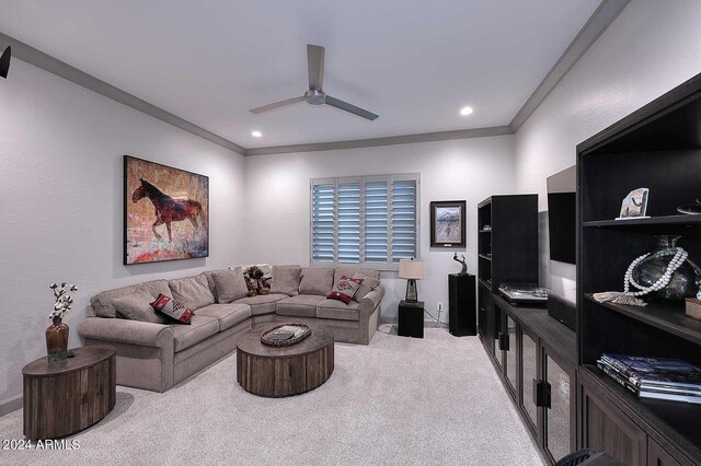 carpeted living room featuring ceiling fan and crown molding