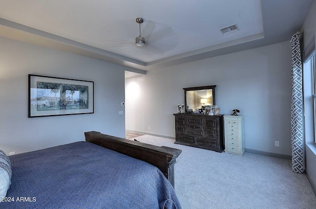 bedroom featuring a tray ceiling, ceiling fan, and carpet floors