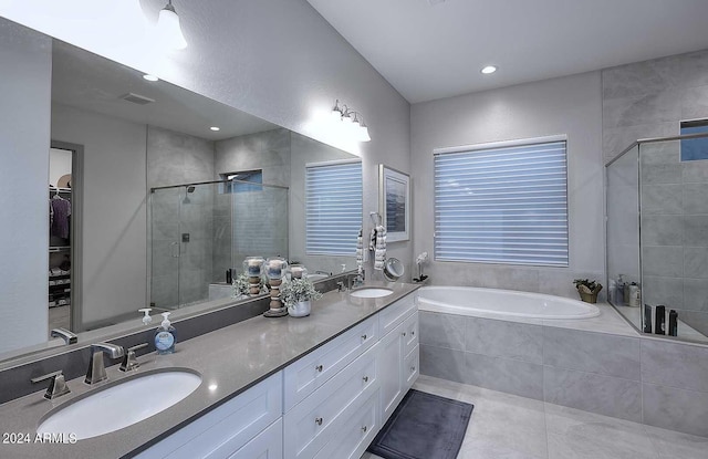 bathroom featuring tile patterned flooring, vanity, and separate shower and tub