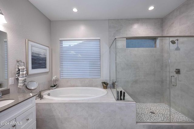 bathroom with vanity and independent shower and bath