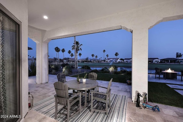 patio terrace at dusk with a fire pit