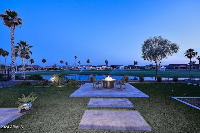 yard at dusk with a patio area