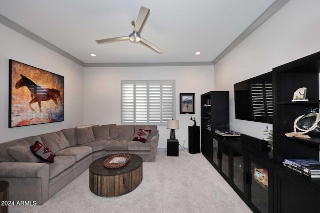 living room featuring light colored carpet, ceiling fan, and ornamental molding