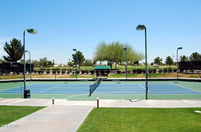 view of sport court with a yard