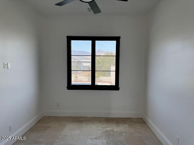 spare room with ceiling fan