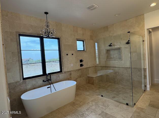 bathroom featuring a chandelier, tile walls, and shower with separate bathtub