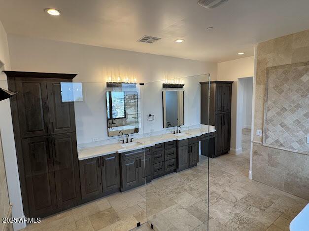 bathroom with a tub and vanity