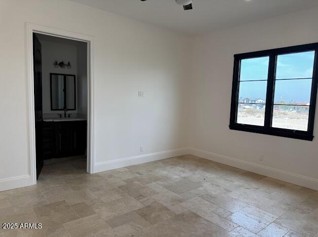 empty room with ceiling fan and sink