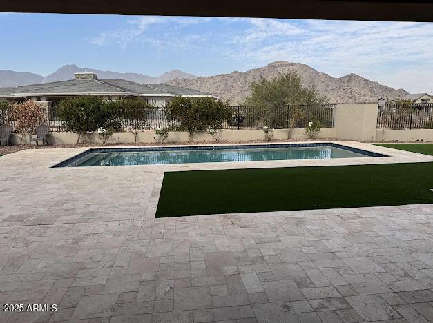 view of pool featuring a mountain view and a patio area