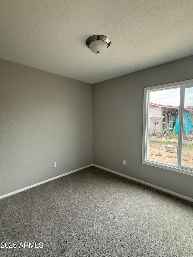 3749 W Gelding Dr, Phoenix, AZ 85053 - carpeted empty room with baseboards and a textured ceiling