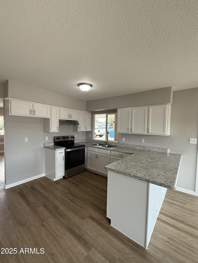 3749 W Gelding Dr, Phoenix, AZ 85053 - kitchen featuring stainless steel electric range, a peninsula, under cabinet range hood, white cabinetry, and a textured ceiling