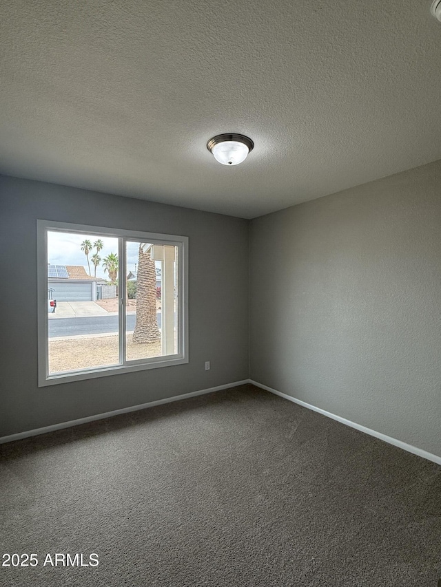 3749 W Gelding Dr, Phoenix, AZ 85053 - unfurnished room with carpet floors, baseboards, and a textured ceiling