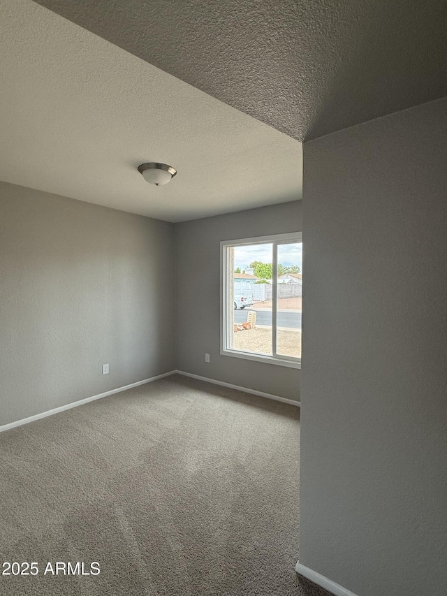 3749 W Gelding Dr, Phoenix, AZ 85053 - carpeted empty room featuring baseboards and a textured ceiling