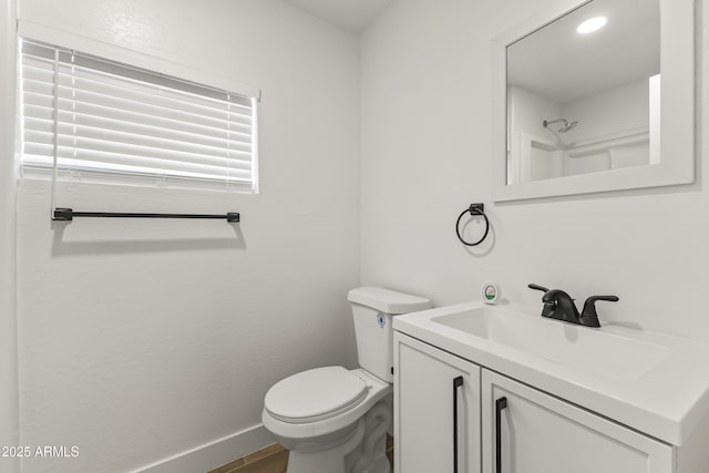 5808 W Myrtle Ave, Glendale, AZ 85301 - bathroom featuring toilet, vanity, baseboards, and wood finished floors
