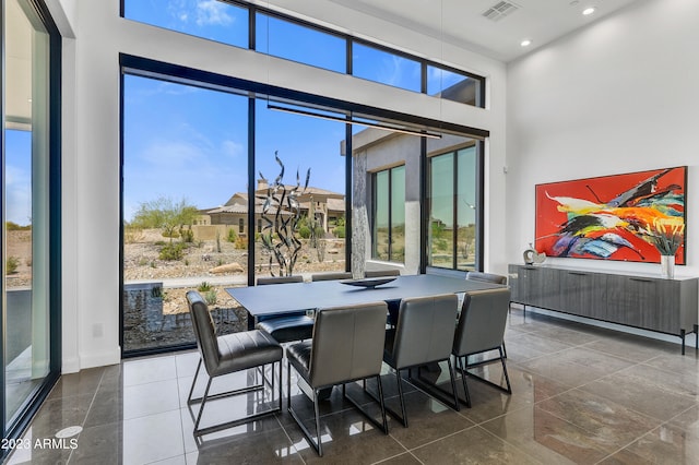 dining area featuring a high ceiling