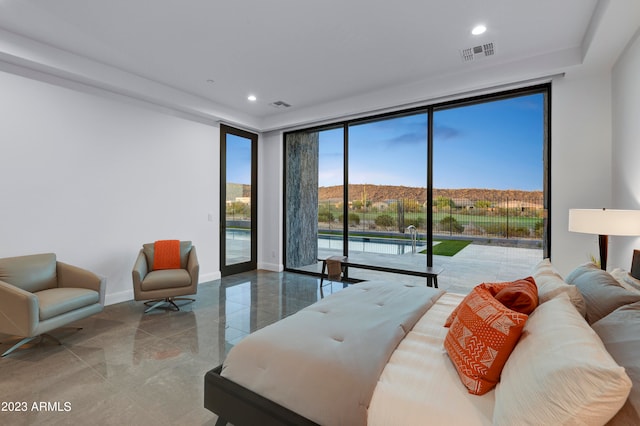 bedroom featuring a mountain view and access to outside