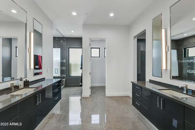 bathroom with vanity and a shower with door