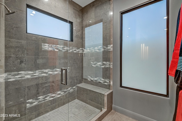 bathroom with walk in shower and tile patterned flooring