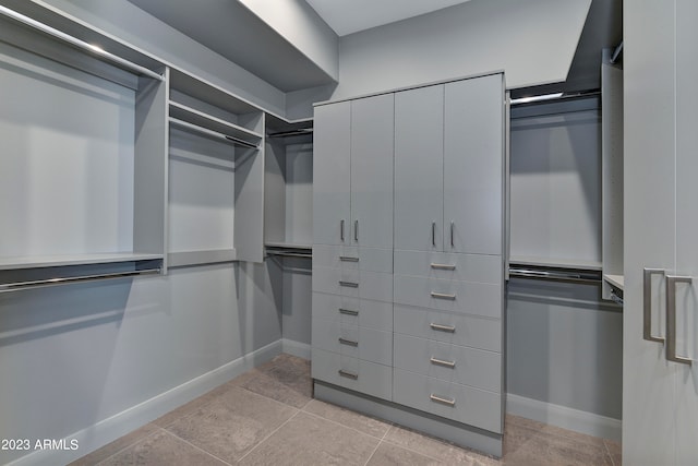 spacious closet featuring light tile patterned floors