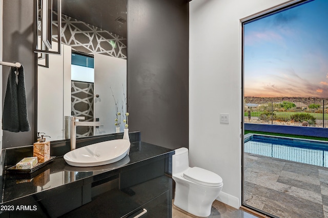 bathroom featuring vanity and toilet