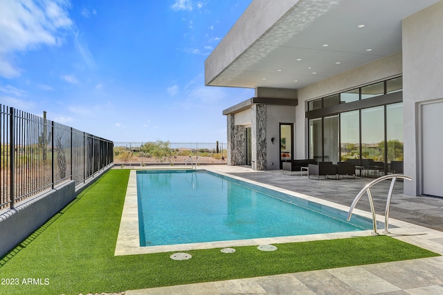 view of pool with outdoor lounge area and a patio area