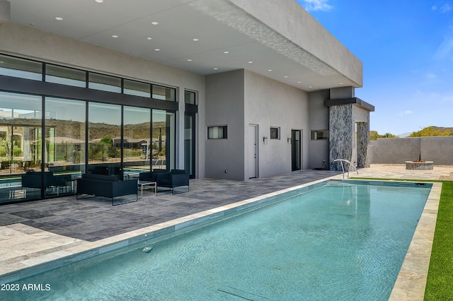 view of pool featuring a patio area and a fire pit