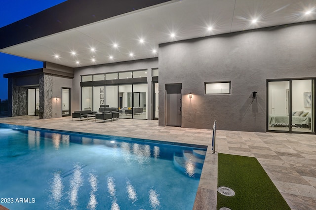 view of pool with an outdoor living space and a patio