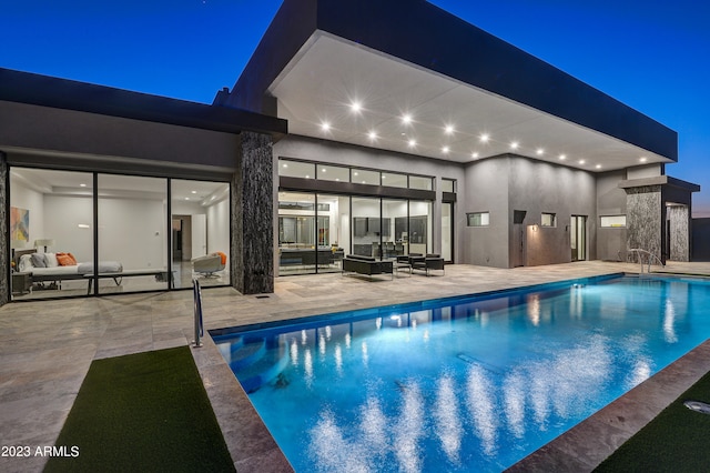 view of swimming pool with an outdoor living space and a patio area