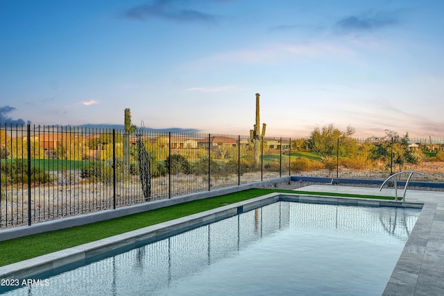 view of pool at dusk