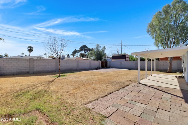 view of yard featuring a patio area and a fenced backyard