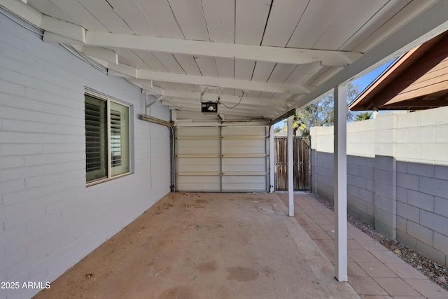 garage featuring a garage door opener and fence