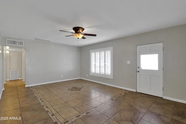 entryway with tile patterned flooring, visible vents, ceiling fan, and baseboards