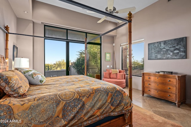 bedroom with access to exterior, a high ceiling, multiple windows, and ceiling fan