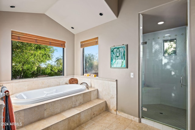 bathroom featuring tile patterned flooring, vaulted ceiling, and independent shower and bath