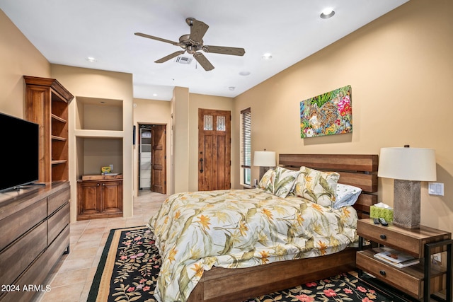 tiled bedroom featuring ceiling fan