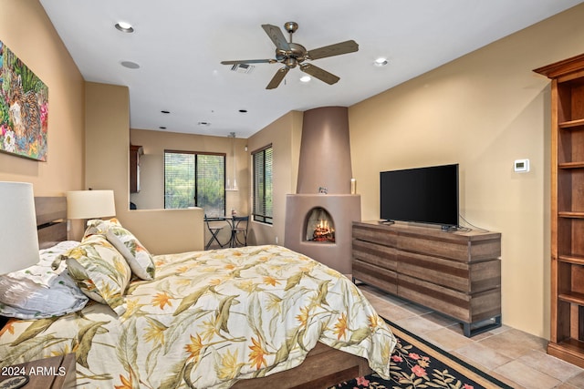 bedroom with ceiling fan and light tile patterned flooring