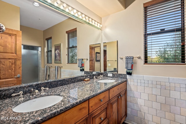 bathroom with vanity and tile walls